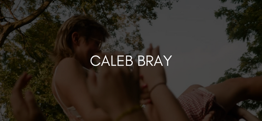 Text reads Caleb Bray on a black overlayed image of a person crowd surfing outside.