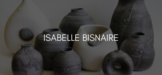 Text reads Isabelle Bisnaire on a black overlayed image of many pieces of pottery in grey and white.